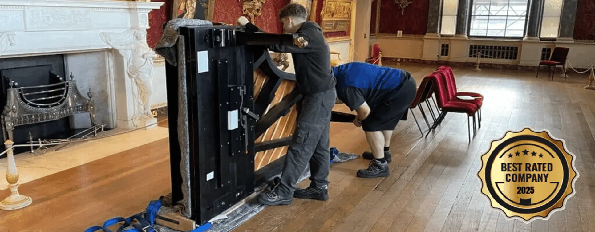Specialist team moving a grand piano inside a grand hall